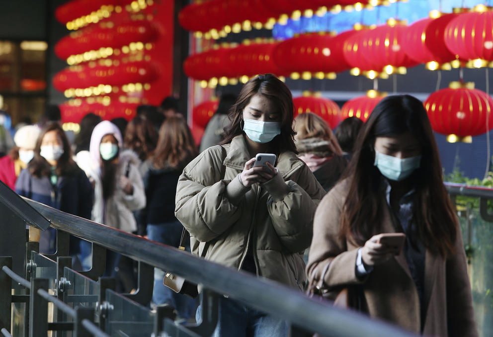 A line of people in respiratory masks