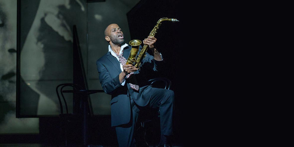 a man on stage with a saxophone