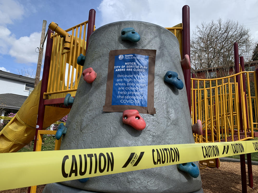 A playground shut down with caution tape