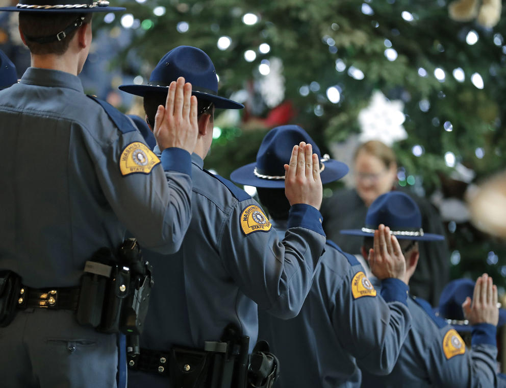 State troopers with hands up at a swearing in ceremony