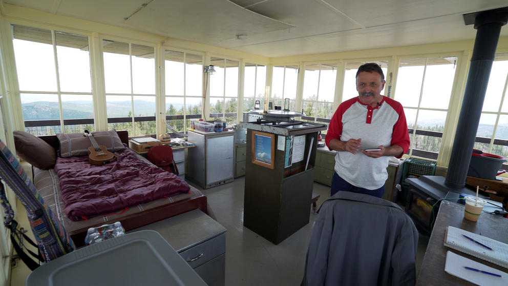 Bill Austin stands in his lookout tower on Leecher Mountain