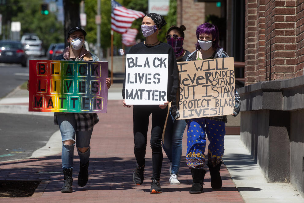 protesters with Black Lives Matter sign