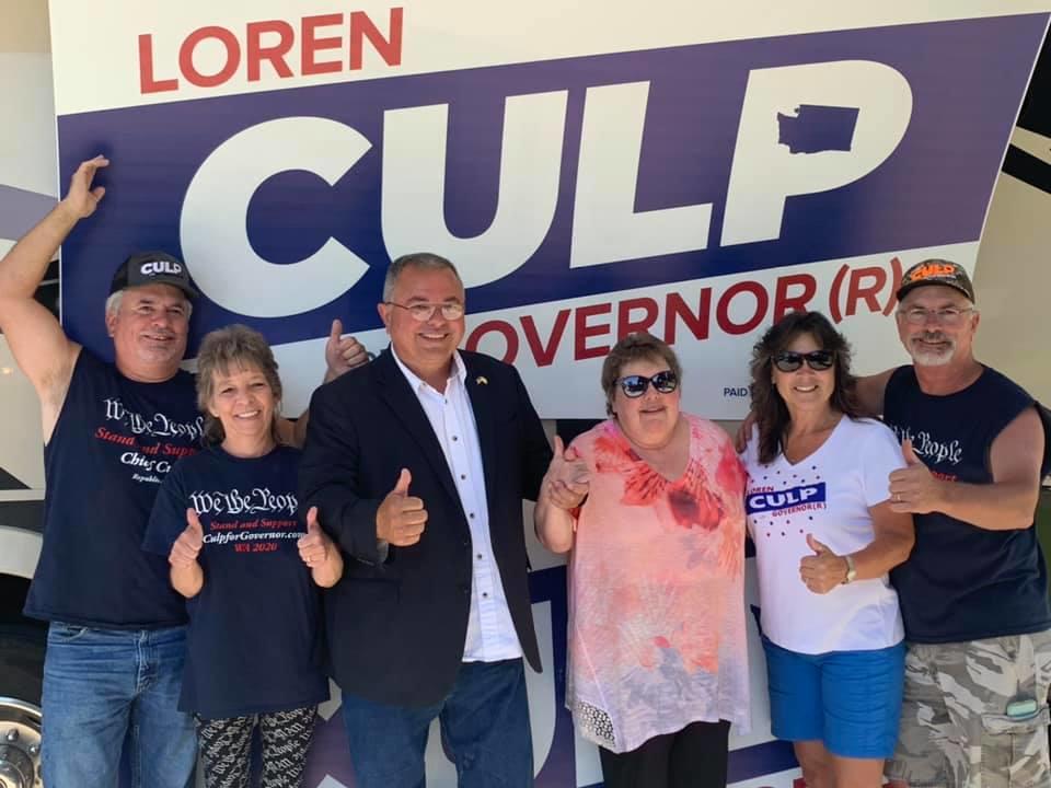 Culp and supporters stand in front of Culp campaign sign
