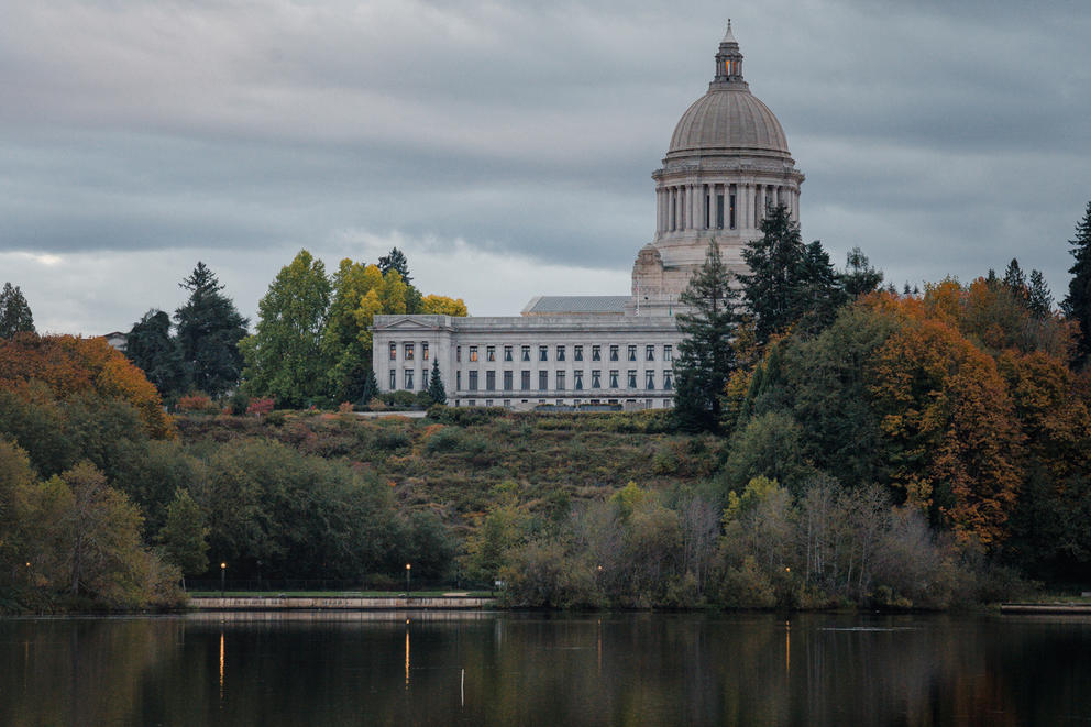 The dome of the Washington State Legislative Building emerges from behind trees 