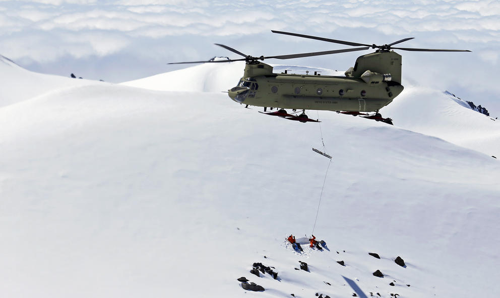 Rescue helicopter over snowy mountain