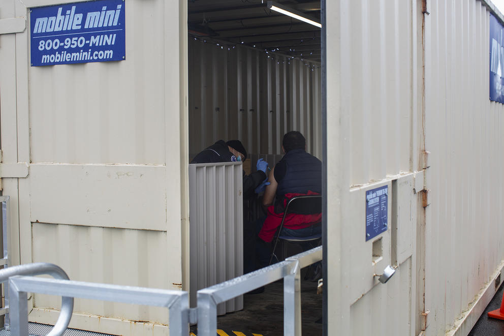 people inside trailer administering vaccines