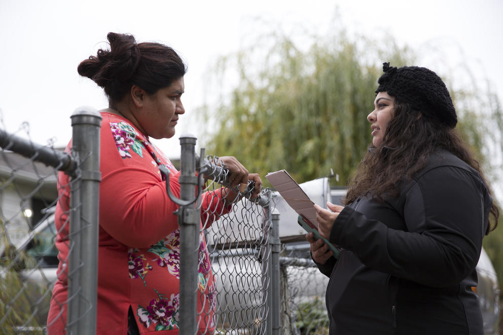District 1 City Council candidate Eliana Macias, 28, speaks with resident Elizabeth Hererra while canvassing in Yakima, Wash. in this, Oct. 20, 2019 file photo. Macias won her election that year. A coalition of Yakima Valley voters says the newly redrawn 15th Legislative District dilutes Latino voter strength by excluding key Latino communities. (Jason Redmond for Crosscut)