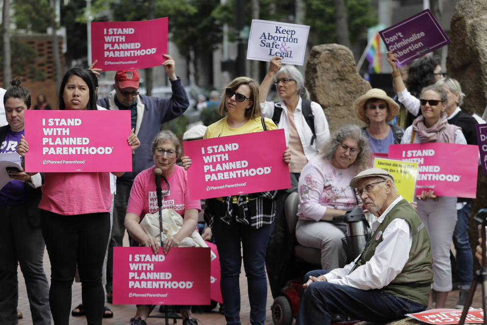 protesters holding signs supporting Planned Parenthood in Seattle