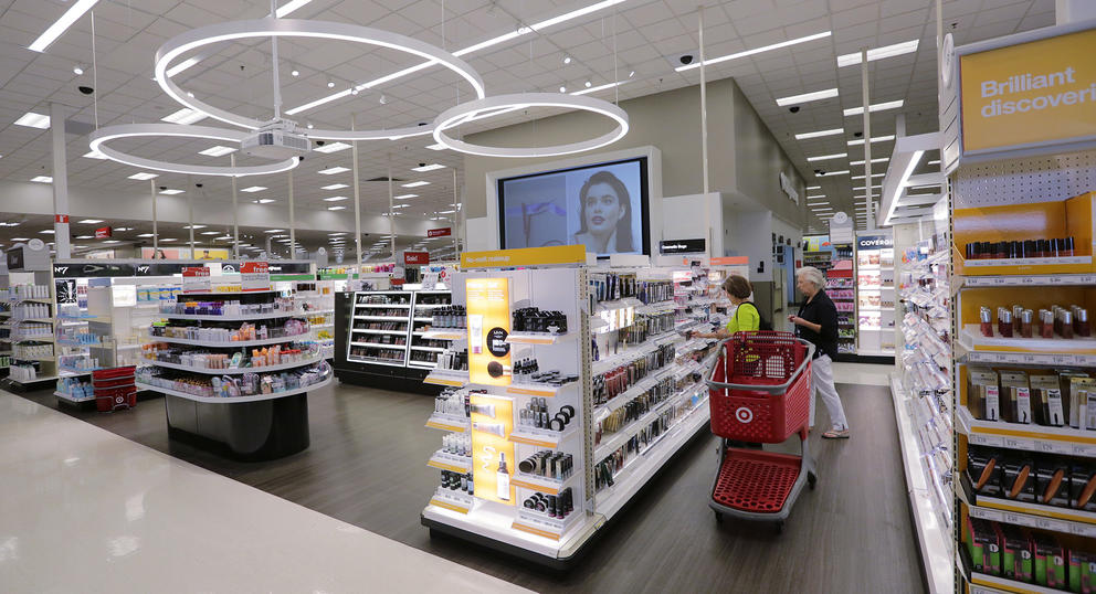 People browse cosmetics aisles at a Target store