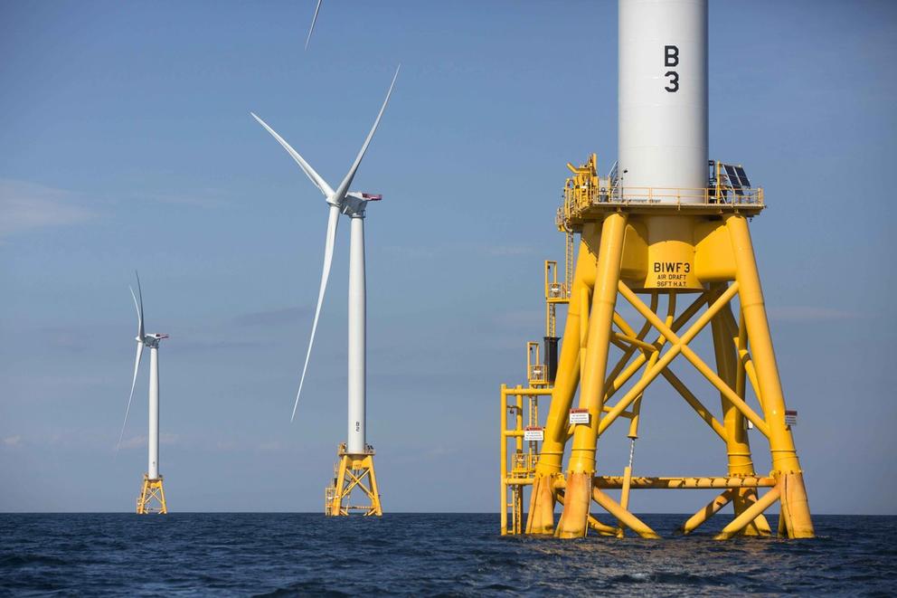 Three floating wind turbines on the ocean