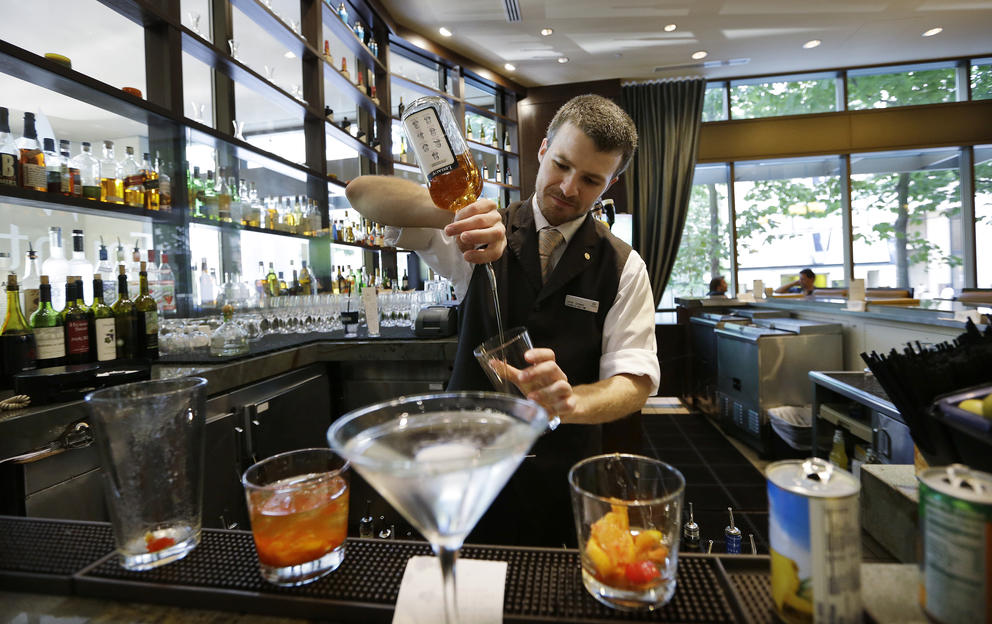 A bartender makes a cocktail