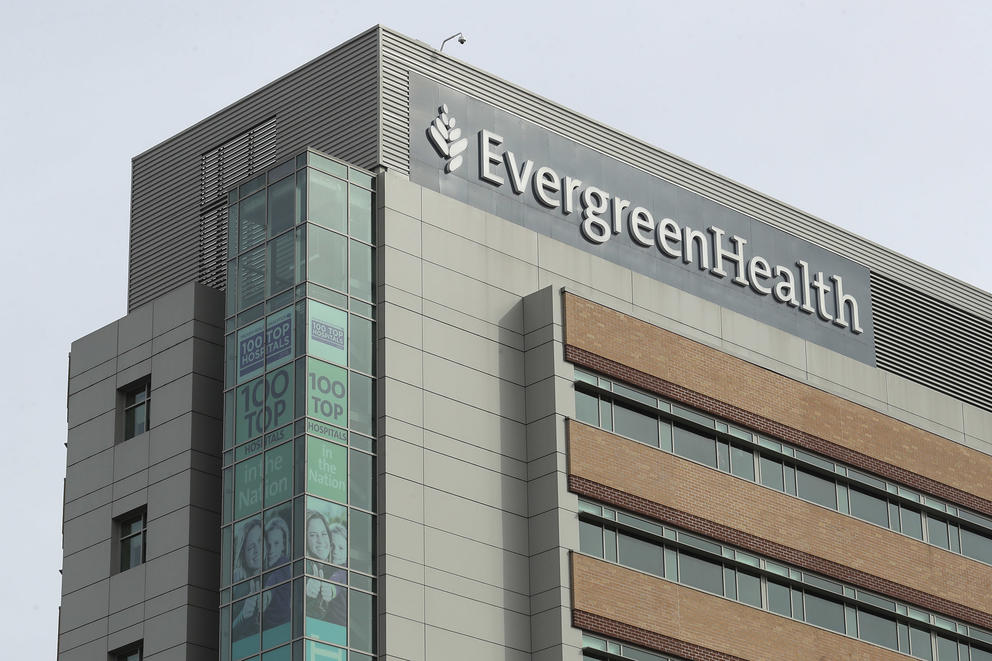 The top corner of the EvergreenHealth hospital in Kirkland stands against a gray sky.