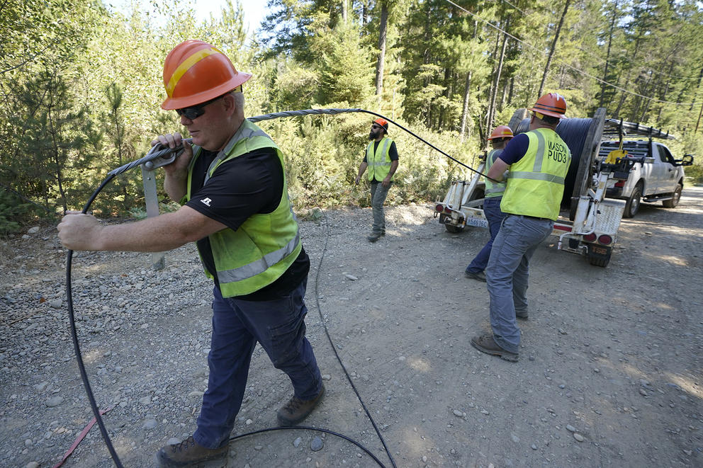 workers install fiber optic cables