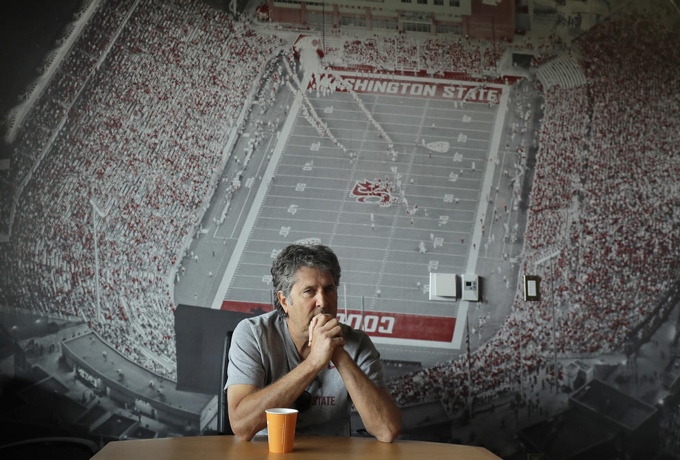 Coach Leach sitting in a conference room