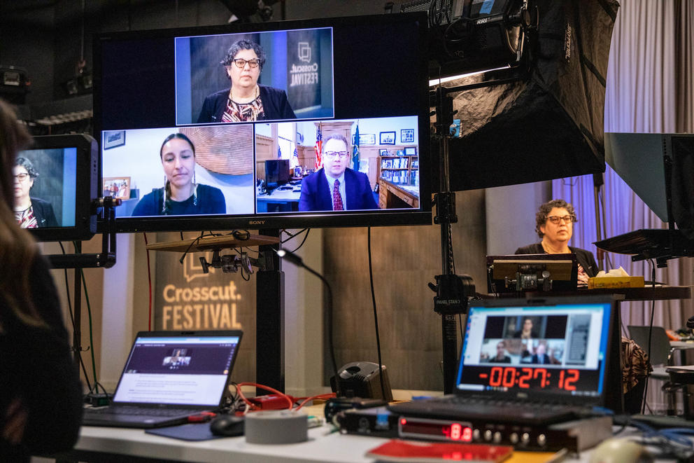 A panel of three people appears on a screen at Cascade Public Media's studios.