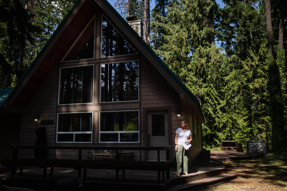 A real estate broker stands around a home in Ronald, Washington