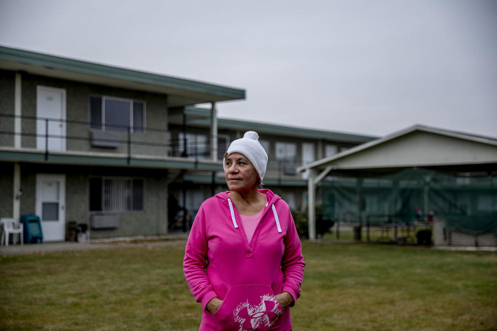 Paula Zambrano stands in front of an apartment building