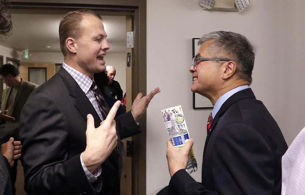 Tim Eyman speaks to Gary Locke at an October 2018 event put on by I-1000 supporters.