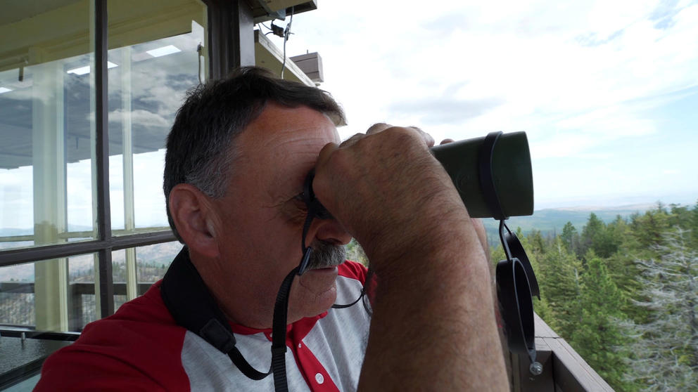 Bill Austin looks through his binoculars.