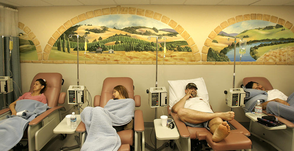 Patients sit in medical reclining chairs to receive medication
