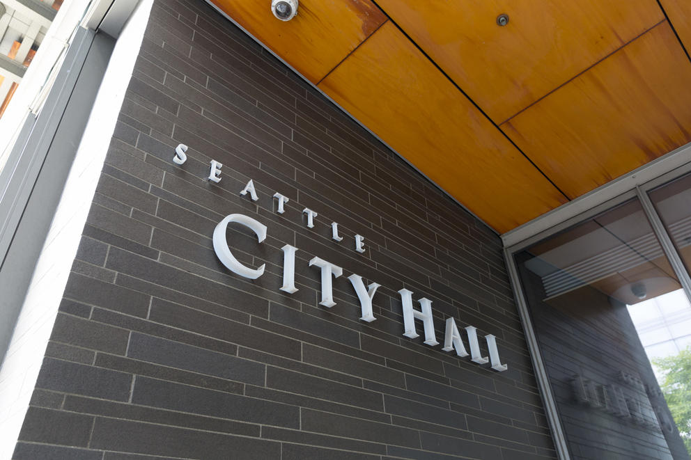 A sign outside city hall reads "Seattle's City Hall" 