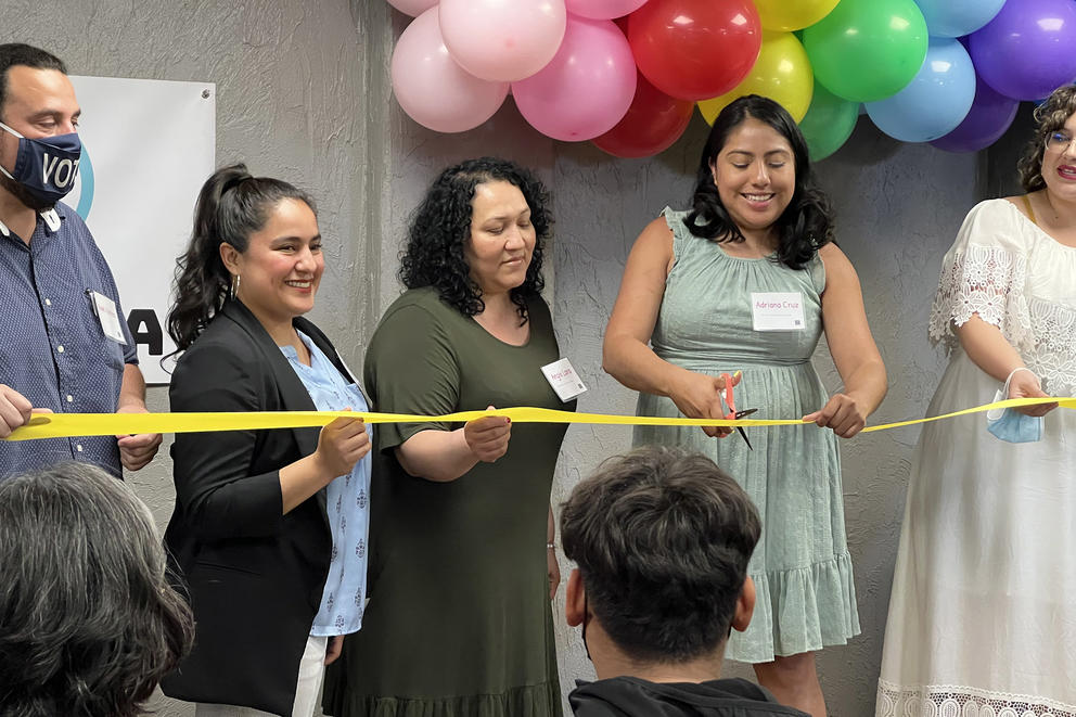 Members of the Fair Work Center hold a ribbon to commemorate the opening of Centro Chinampa, a worker and immigrant rights center in Yakima