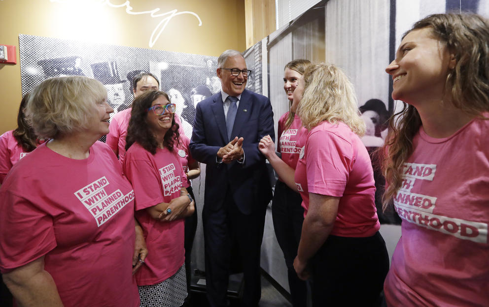 Gov. Jay Inslee talks with supporters of Planned Parenthood