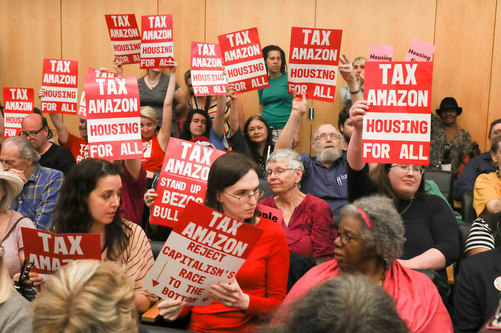 Protesters with tax amazon signs