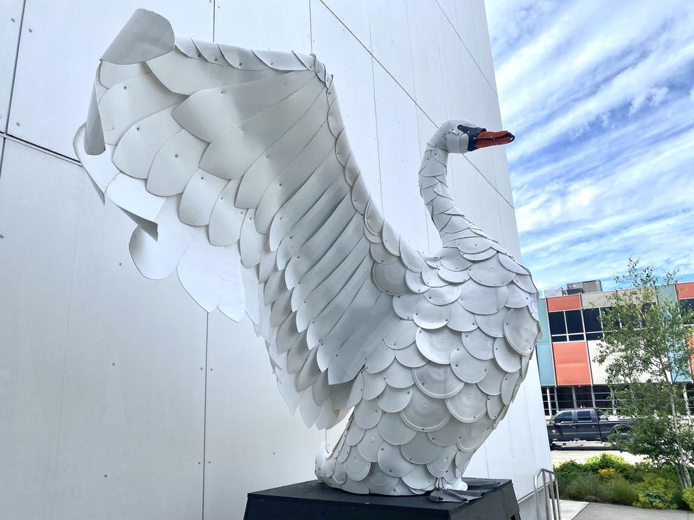 a giant white swan made out of plastic buckets
