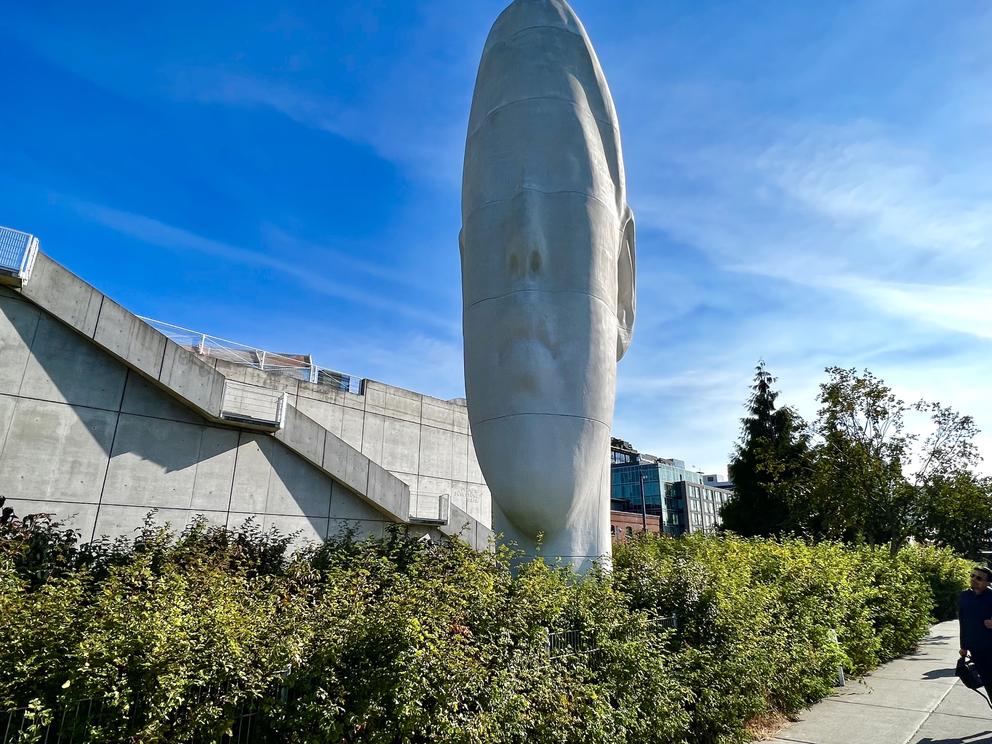 photo of a large white sculpture of a girl's face