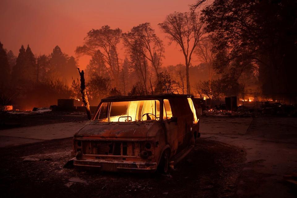 Paradise California fire shows a van engulfed in flames amidst a burning forest