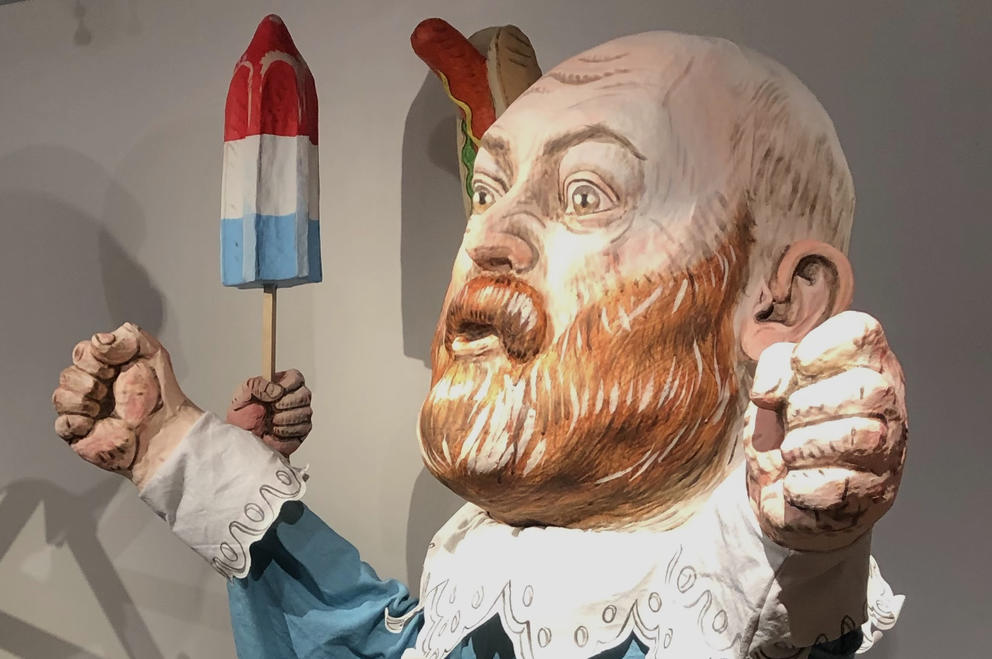 a large puppet of a bald man with a red beard