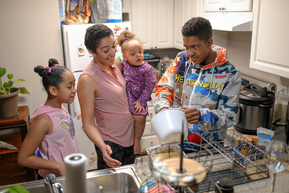 Sequoia Dolan and her children Jaeleah, 10, Zayah, 2, and Marquis, 13, make cornbread as they prepare dinner together at home.