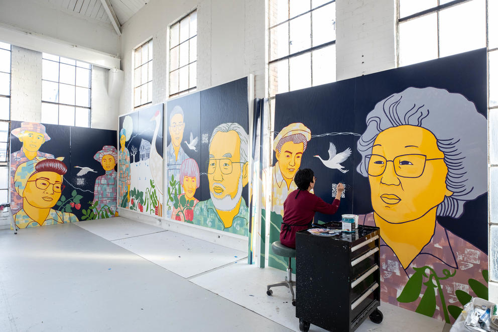 big murals being painted in an airy studio