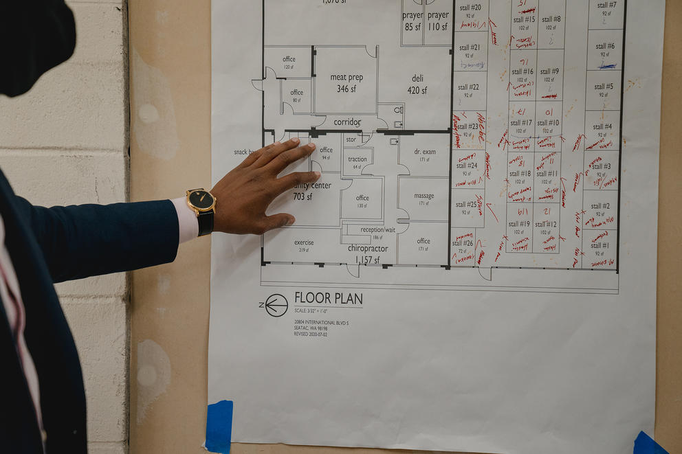 pointing at a floor plan for the new mall
