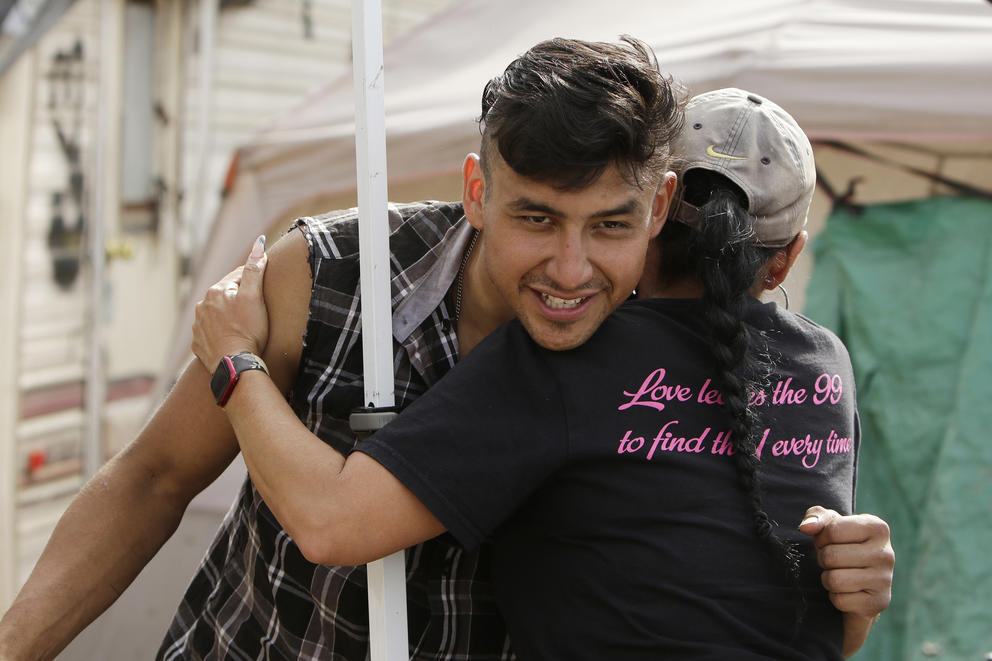 A man hugging a woman at the Camp Hope encampment 