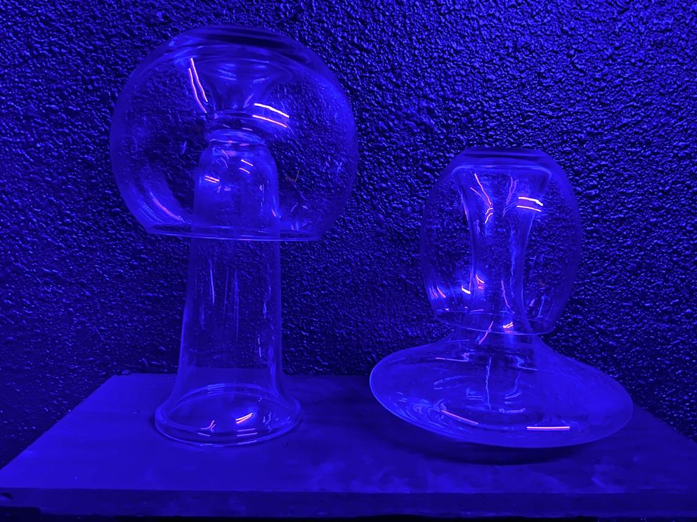an indigo-lit scene of glass that resembles jellyfish