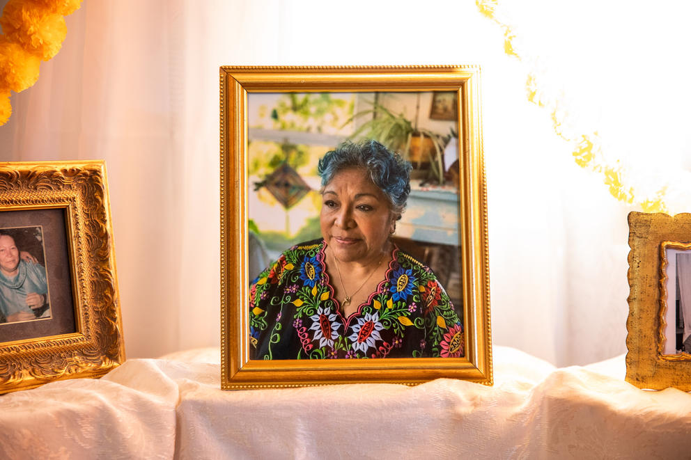 A gold framed photograph of an older woman