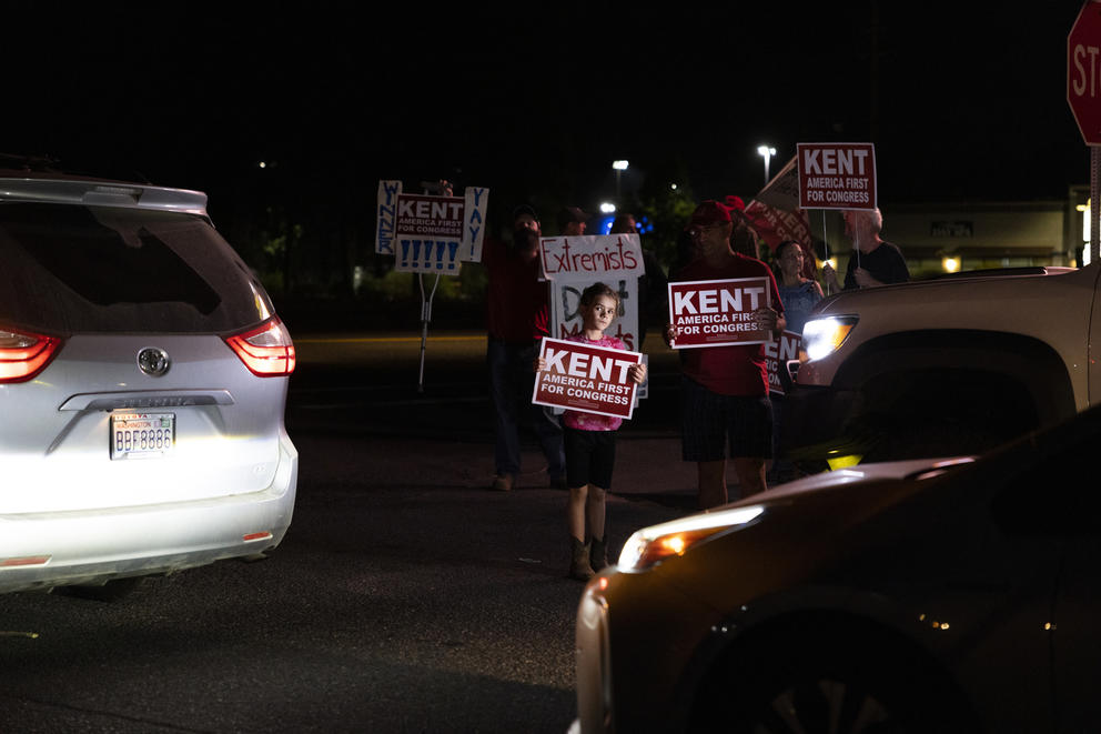 Supporters wave signs after the debate