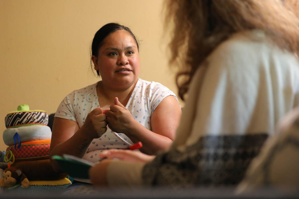 Open Arms outreach doula Margarita Celis, right, visits with one of her clients.
