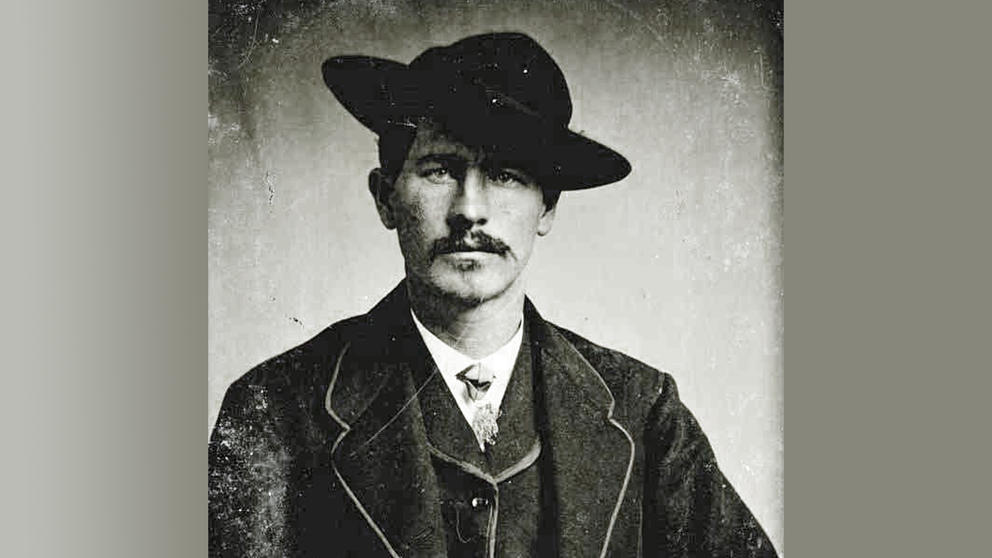 Wyatt Earp seen wearing a wide brimmed hat and business suit.