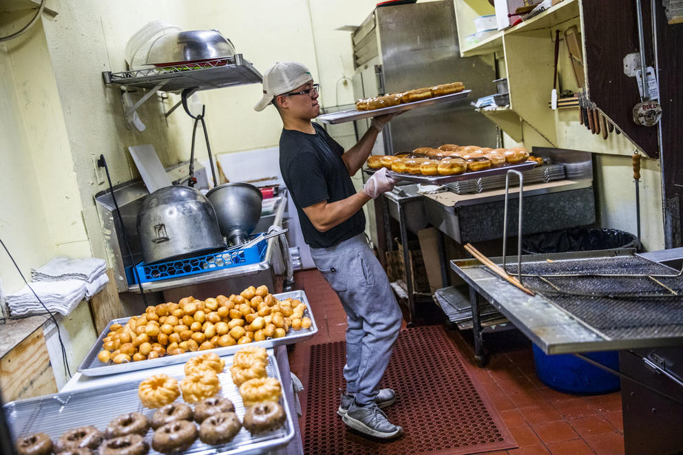 Travis Chhuor, 30, prepares doughnuts in the morning at King Donuts in Rainier Beach on Sunday, Nov. 18, 2018. Chhuor is the sole baker for the shop and often gets to work at 3 a.m.to start on the day's doughnuts.