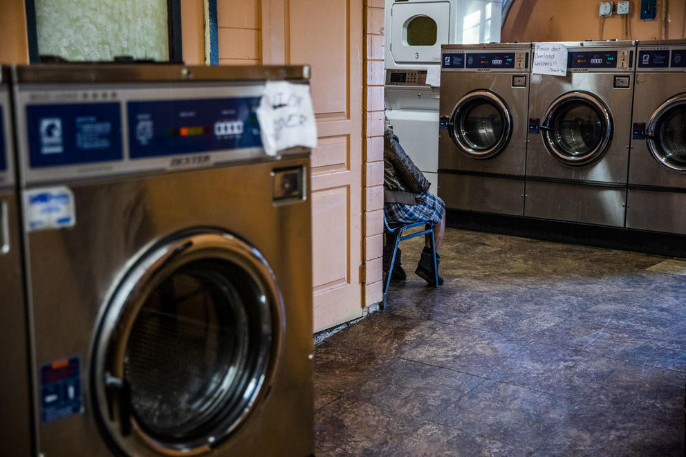 A woman waits for her laundry to finish at King Donuts in Rainier Beach on Sunday, Nov. 18, 2018.