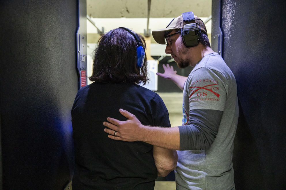 John Abbitt instructs Melissa Elmer, 68, as she learn how to shoot a gun for the first time at West Coast Armory in Bellevue during a Pink Pistols range meetup on May 18, 2019. Melissa recently got her concealed pistol license and came to Pink Pistols with her wife to learn how to shoot it. Abbitt is regularly involved with gun education in Pink Pistols. “It builds your confidence,” Abbitt says. “You can say ‘you know, I’m good’.” (Photo by Dorothy Edwards/Crosscut)