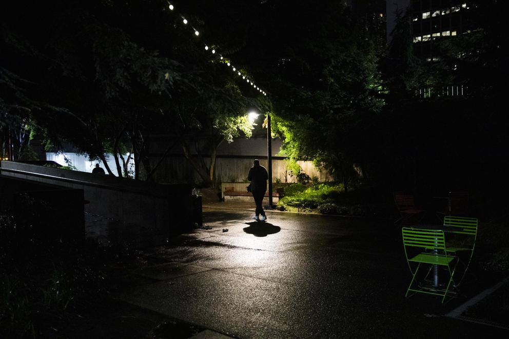 Dwight walks under street lamp at night