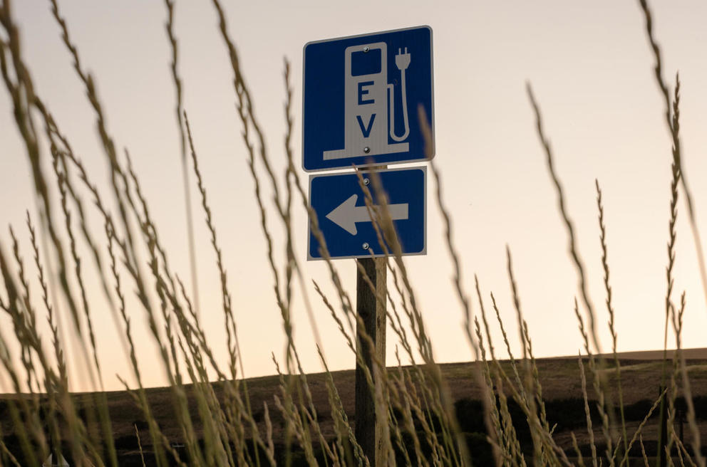 Sign with a symbol of an EV charger and an arrow