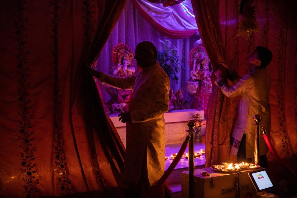 Two priests unveil lit diyas