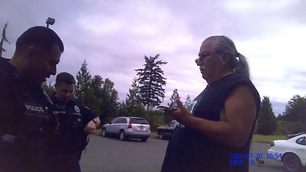 George Adams encounters Nooksack police with his lawyer on the phone