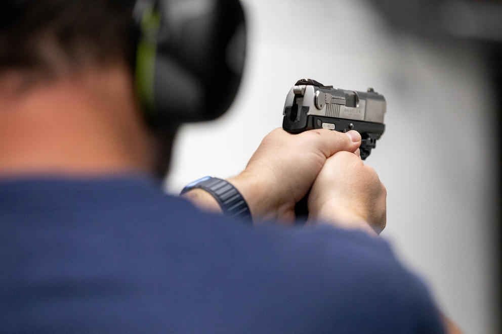 Visitor does target practice at gun range