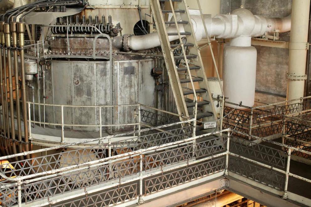 stairs and walkways plus large turbines in a century-old steam plant